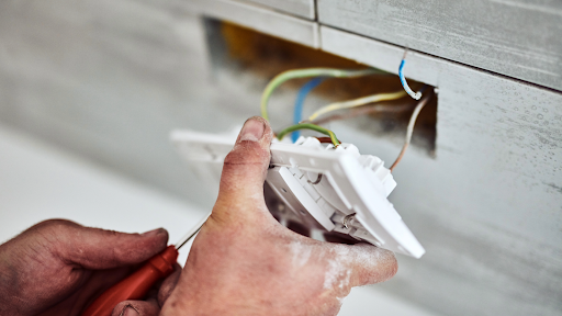 Electrician fixing outdated wiring in Hudson Florida home